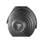 Close-up of a headphone driver with a circular perforated metal grille and central logo, showing the text 'Bathys MG' and 'Magnésium'.