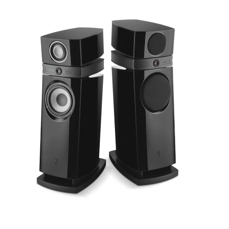 Pair of tall black floor-standing stereo speakers with silver woofer cones facing outward, angled inward toward the listening area