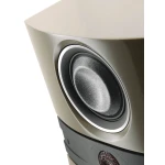 Close-up of a beige speaker showing a large woofer cone and surrounding ring, emphasizing the speaker design.