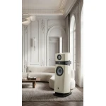 Elegant white-paneled living room with a tall cream floor-standing speaker beside a curved beige sofa and wooden coffee table.