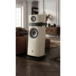 Luxury white floor-standing speaker system with a subwoofer in a refined living room setting.