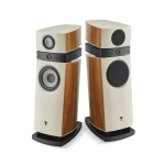 Pair of cream-colored floor-standing speakers with wood veneer panels and black drivers, facing each other in a studio setup.